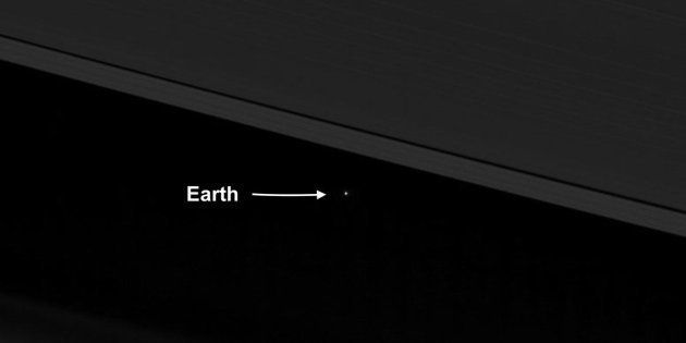 An April 12 image from NASA's Cassini spacecraft shows Earth as a point of light between the icy rings of Saturn. Cassini was 870 million miles from Earth when the image was taken. 