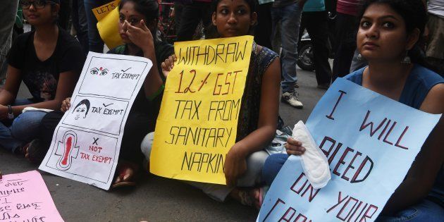 Indian students hold posters and sanitary napkins during a protest over a 12 per-cent tax on sanitary pads as part of the Goods and Services Tax (GST) in Kolkata.