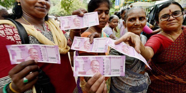 Chennai: Women show their new Rs 2000 notes after exchanging their old Rs 500 and Rs 1000 notes at a bank in Chennai on Thursday.