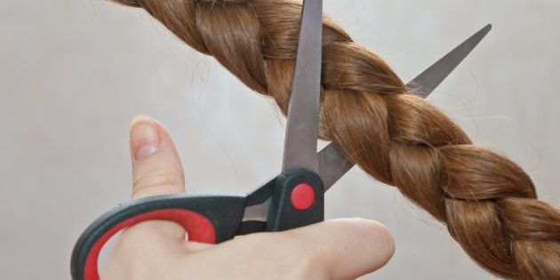 close-up of cutting off a braid