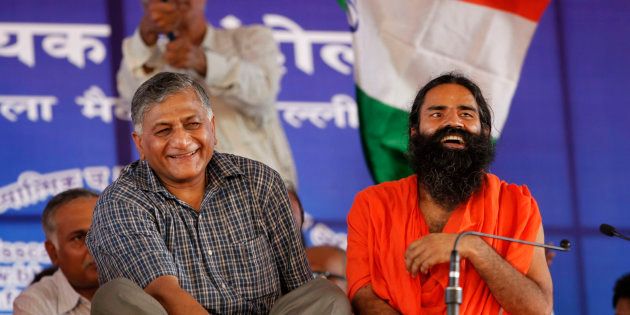 Baba Ramdev, right, seated next to retired former Indian Army chief General V.K. Singh during a protest in New Delhi in 2012. (AP Photo/Rajesh Kumar Singh)