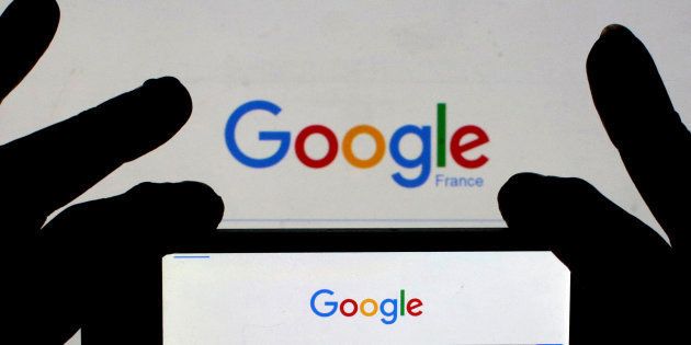 A woman holds her smart phone, which displays the Google home page, in this picture illustration taken February 24, 2016. REUTERS/Eric Gaillard/Illustration/File Photo