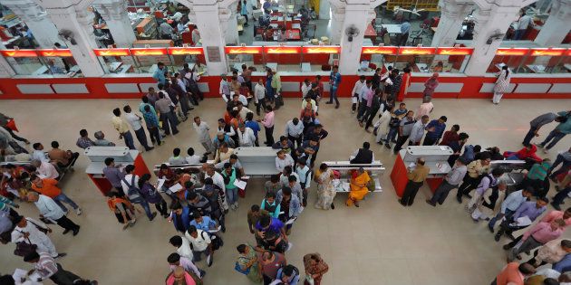People wait in lines to deposit and withdraw money inside a post office in Lucknow, India, November 10, 2016. REUTERS/Pawan Kumar
