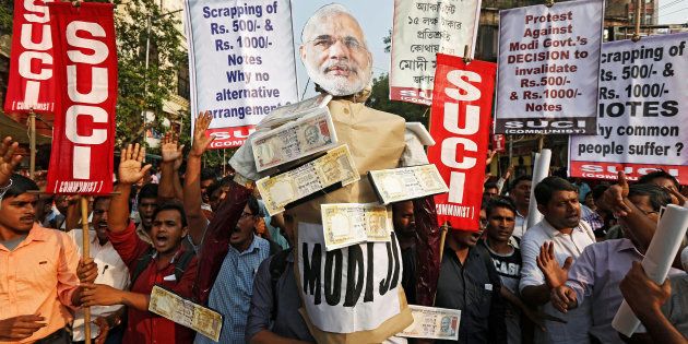 Activists of Socialist Unity Centre of India (SUCI) shout slogans as they carry an effigy of Prime Minister Narendra Modi during a protest against the government's decision to withdraw 500 and 1000 Indian rupee banknotes from circulation, according to a media release, in Kolkata, India, November 14, 2016. REUTERS/Rupak De Chowdhuri