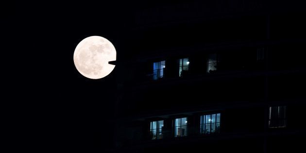A supermoon rises in front of a high-rise building in Kolkata on November 14, 2016.