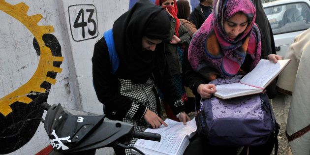 Students revise for the last time before entering exam centre as class 12 state board exams started in Kashmir amidst tight security.