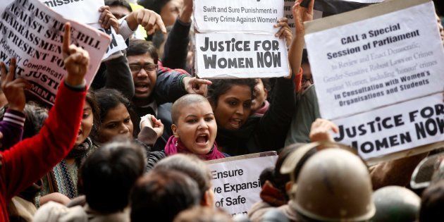 Demonstrators shout slogans as policemen are trying to stop them from approaching a barricade on their way to India Gate while protesting against a gang-rape on December 27, 2012.
