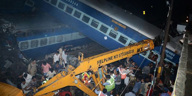 Emergency workers look for survivors on the wreckage of a train carriage after an express train derailed near the town of Khatauli in the Indian state of Uttar Pradesh on August 19, 2017.