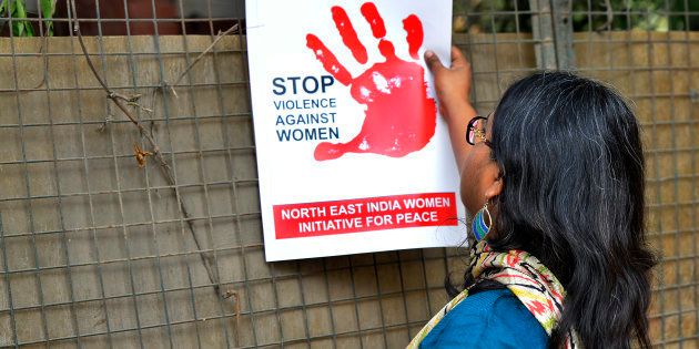 FILE PHOTO: A woman protests against the brutal assault and rape of 24 year old girl in Hauz Khas village in New Delhi.