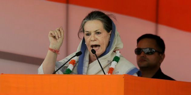 India's opposition Congress president Sonia Gandhi addresses a farmers rally in New Delhi, India, Sunday, April 19, 2015. Tens of thousands of flag-waving farmers rallied in India's capital on Sunday to protest the government's plan to ease rules for obtaining land for industry and development projects.(AP Photo/Altaf Qadri)