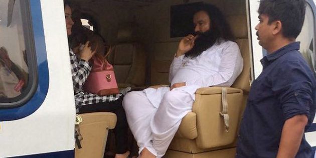 Panchkula: Dera Sacha Sauda chief Gurmeet Ram Rahim in a helicopter in which he was flown from Panchkula to Rohtak town to lodged in jail on Friday. PTI Photo(PTI8_25_2017_000234B)