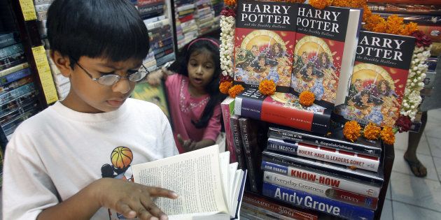 A young reader reads leafs through a copy of Harry Potter and the Deathly Hallows at a bookshop in New Delhi.