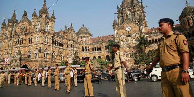 Indian policemen stand guard outside the Chhatrapati Shivaji train station, one of the sites of the 2008 terror attack.