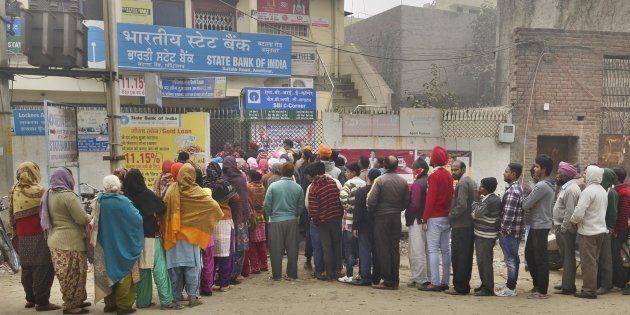 Despite cold weather people queuing outside the State Bank of India branch to get cash at Batala Road on December 29, 2016 in Amritsar.