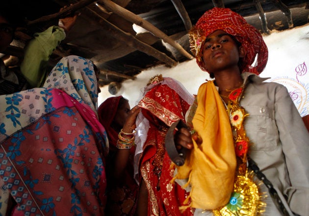 Kishan Gopal (R), 13, returns home with his 11-year-old newly wed wife Krishna in a village near Kota in the north-western state of Rajasthan, May 16, 2010.