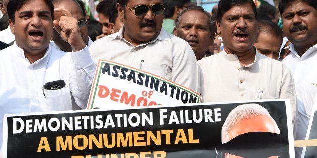 Indian Congress Party supporters shout slogans during a protest against demonetisation at the Reserve Bank of India in Mumbai on January 18, 2017.