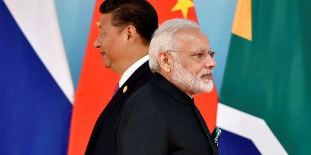 Chinese President Xi Jinping (L) and Indian Prime Minister Narendra Modi attend the group photo session during the BRICS Summit at the Xiamen International Conference and Exhibition Center in Xiamen.