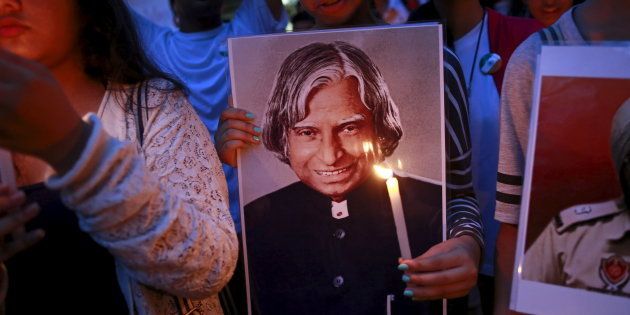 A student holds a portrait of former Indian President A. P. J. Abdul Kalam during a candle light march in Mumbai.