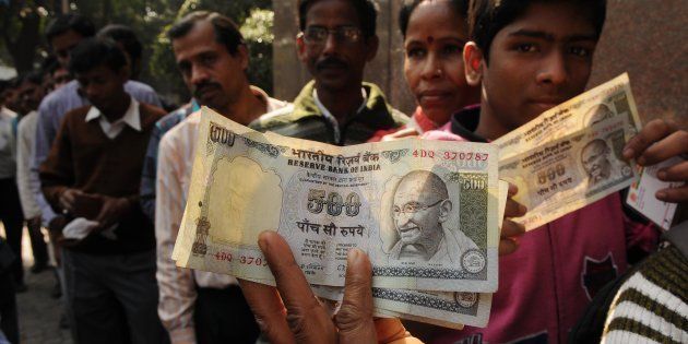 People in queue waiting outside bank with old 500 Rs. notes in front of RBI.