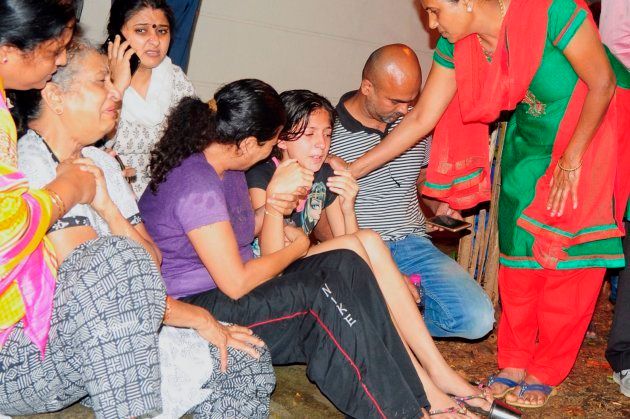 Family members and relatives of 55-year-old Gauri Lankesh, who was shot dead by unknown assailants in the porch of her home in Bangalore mourn her death overnight on September 5, 2017.