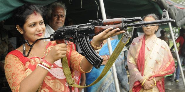 [REPRESENTATIONAL IMAGE] File photo of a housewife trying to hold an AK-47 rifle during an exhibition in Kolkata.