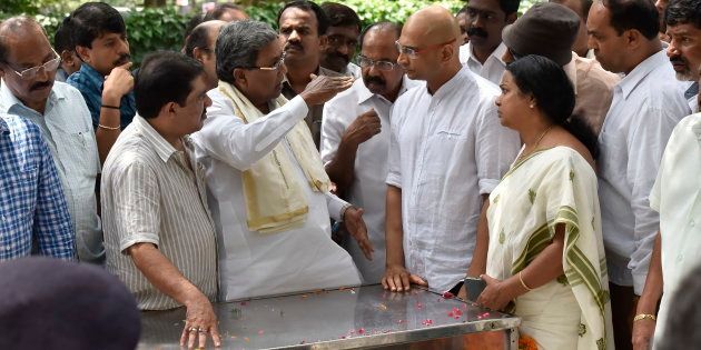 Karnataka chief minister Siddaramaiah speaks to Indrajit brother of the slain journalist Gauri Lankesh as her mortal remains kept at Town hall on September 6, 2017 in Bengaluru, India.