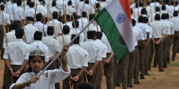 A child holding the national flag as Rashtriya Swayamsevak Sangh (RSS) volunteers line up ahead of a march in Hyderabad on October 9, 2016. NOAH SEELAM/AFP/Getty Images