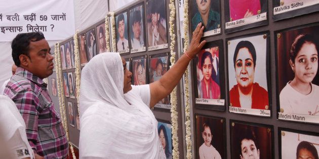 Relatives of the victims who died in a fire at Uphaar cinema hall on the occasion of the 15th anniversary of the tragedy. (Photo by K Asif/India Today Group/Getty Images)