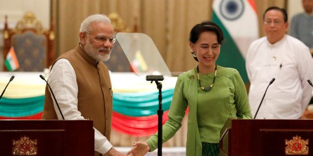 India's Prime Minister Narendra Modi and Myanmar's State Counselor Aung San Suu Kyi talk to reporters during their joint press conference.
