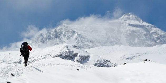 Man climbing up mountain at Mt. Everest.