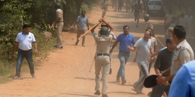 Police use lathis or batons to control protesters, who set fire to liquor shop near Ryan International School, on September 10, 2017 in Gurgaon.