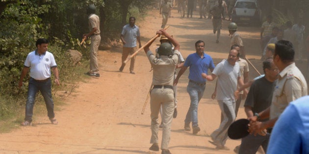 Police use lathis or batons to control protesters, who set fire to liquor shop near Ryan International School, on September 10, 2017 in Gurgaon.