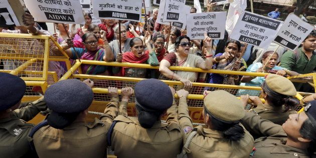 Activists from All India Democratic Women's Association (AIDWA) shout slogans behind a police barricade outside the Haryana Bhawan during a protest in New Delhi, India, February 29, 2016.
