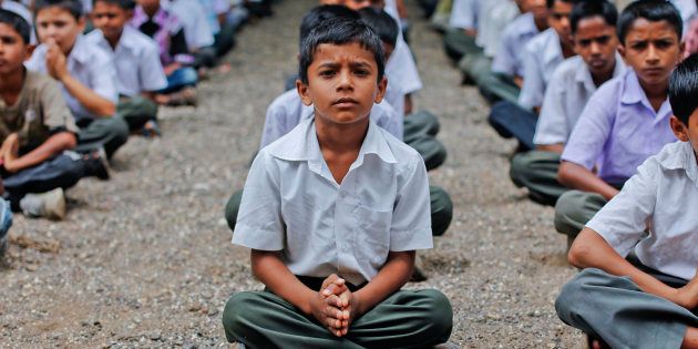 Students pray during their morning assembly at a school in the Ralegan Siddhi village.
