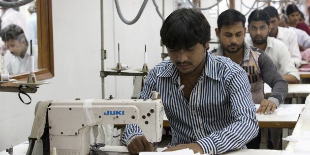 Labourers sew linens at the April Cornell clothing factory in Noida.