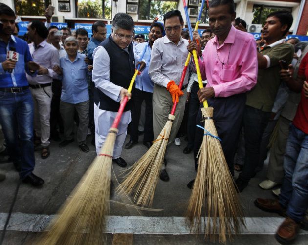 Union Telecom, IT and Law Minister Ravi Shankar Prasad wields broom as he launched cleanliness drive at Shastri Bhawan compound as part of the Prime Minister Narendra Modi's pet project under the Swachh Bharat Mission on September 26, 2014 in New Delhi, India.