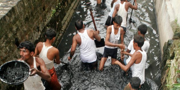 Aspirants to the post of 'safai karamcharis' perform during a practical test conducted by the Allahabad Municipal Corporation in 2008.