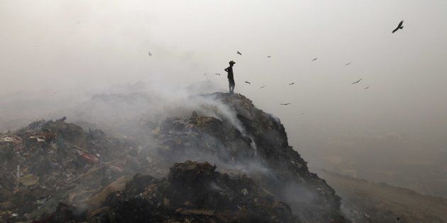 Garbage burning adding pollution to environment at Bhalswa Landfill as smog covers the capital's skyline