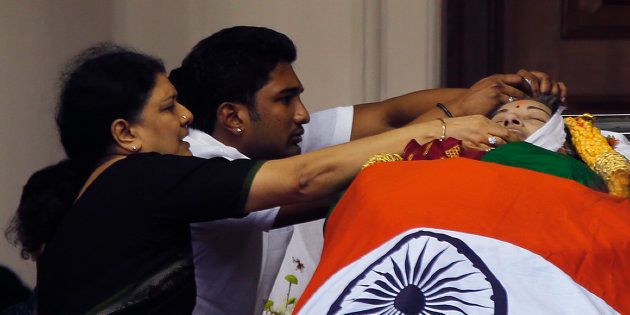 Sasikala Natarajan with the late J Jayalithaa's body. (AP Photo/Aijaz Rahi)