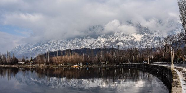 Shikara boats are moored the bank of Dal lake next to the snow clad mountains in Dal Lake on February 06, 2017 in Srinagar, the summer capital of Indian Administered Kashmir, India. Cold weather continued in the Kashmir valley with most places in the state recording sub-zero temperatures.(Photo by Yawar Nazir/Getty Images)