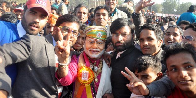 A BJP supporter wearing a mask of Modi during the rally of Prime Minister Narendra Modi at Parade Ground on December 27, 2016 in Dehradun, India.
