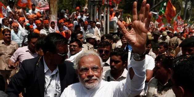 File photo of Narendra Modi, waving to his supporters as he arrives to file his nomination papers for the general elections in the northern Indian city of Varanasi April 24, 2014.