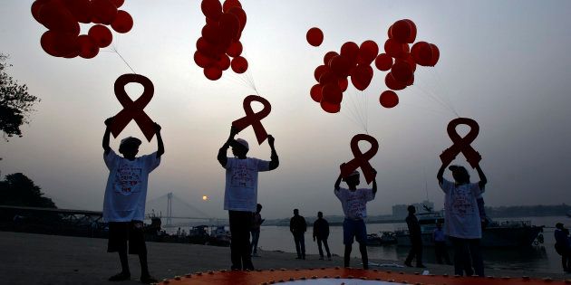Children display ribbon cut-outs tied to balloons during an HIV/AIDS awareness campaign to mark World AIDS Day in Kolkata.