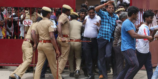 REPRESENTATIVE IMAGE: Policemen try to maintain the order of the fans of Indian superstar Rajinikanth as they enter the premises of a cinema hall where the actor's new movie