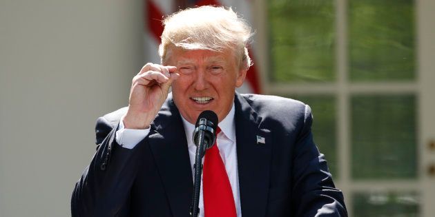U.S. President Donald Trump refers to amounts of temperature change as he announces his decision that the United States will withdraw from the landmark Paris Climate Agreement, in the Rose Garden of the White House in Washington, U.S., June 1, 2017. REUTERS/Kevin Lamarque