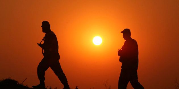 File photo of Indian Border Security Force (BSF) soldiers as they patrol the fenced border with Pakistan at Babiya village in Hira Nagar sector, about 80 km (50 miles) from Jammu December 6, 2013.
