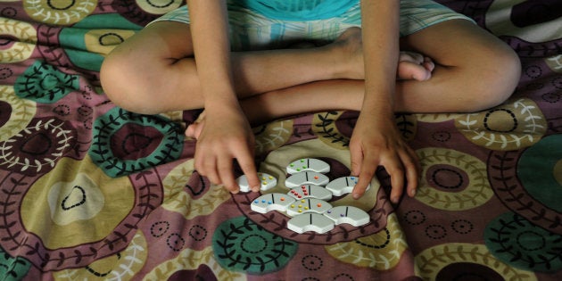 An Indian child effected with HIV/AIDS plays a game at the non-governmental organisation, Naz Foundation Trust, in New Delhi on July 21,2012. More than 34 million people worldwide are living with HIV, a higher number than ever before, and around 30 million have died from AIDS-related causes since the disease first emerged in the 1980s, according to UNAIDS. AFP PHOTO/ SAJJAD HUSSAIN (Photo credit should read SAJJAD HUSSAIN/AFP/GettyImages)