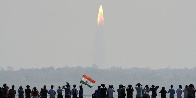 Indian onlookers watch the launch of the Indian Space Research Organisation (ISRO) Polar Satellite Launch Vehicle (PSLV-C37) at Sriharikota on Febuary 15, 2017.