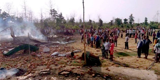 People gather near the site of a fire that took place in firecrackers factory at Balaghat, Madhya Pradesh on 7 June.