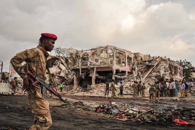 EDITORS NOTE: Graphic content / Somali soldiers patrol on the scene of the explosion of a truck bomb in the centre of Mogadishu, on October 15, 2017.
